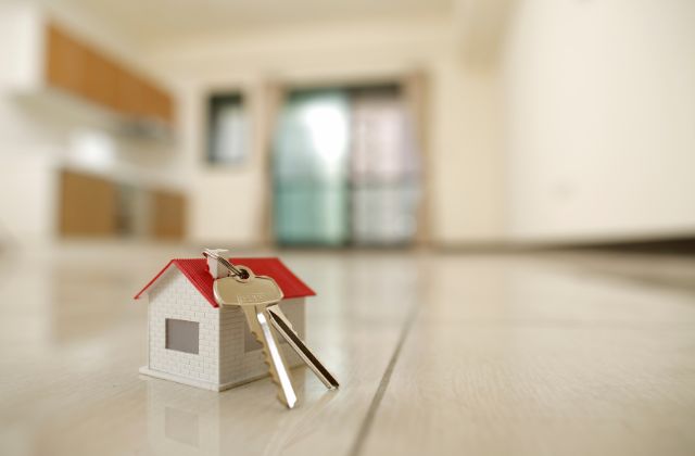 small house with set of keys sitting on top